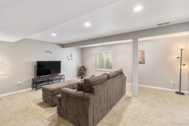 living room featuring light carpet and a textured ceiling