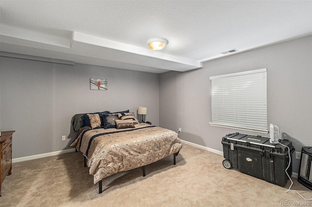 bedroom featuring light colored carpet and a textured ceiling