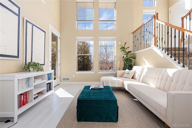 living room featuring a towering ceiling