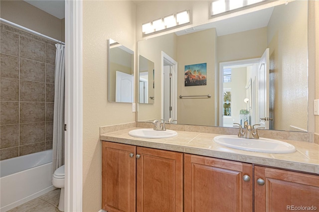 full bathroom featuring shower / bathtub combination with curtain, vanity, tile patterned floors, and toilet