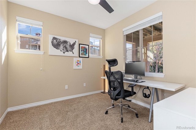 carpeted office space with a wealth of natural light and ceiling fan