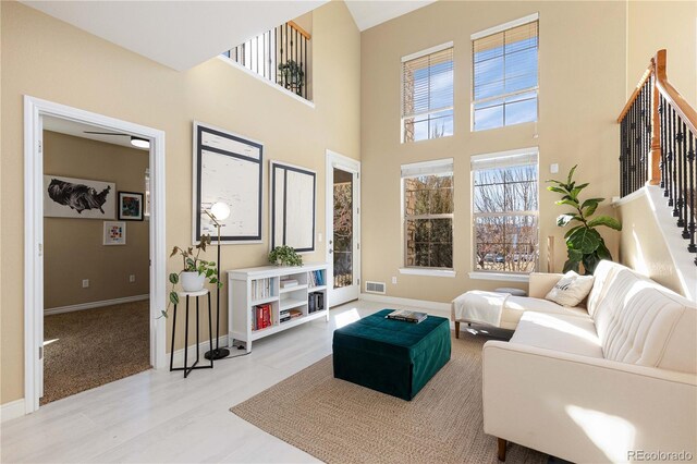 9228 Sori Ln, Highlands Ranch, CO 80126 - living area with stairs, baseboards, a high ceiling, and wood finished floors