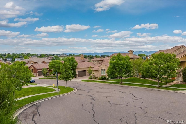 9228 Sori Ln, Highlands Ranch, CO 80126 - view of asphalt street featuring a residential view, sidewalks, curbs, and a mountain view