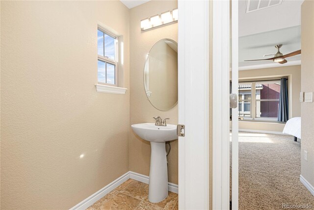 9228 Sori Ln, Highlands Ranch, CO 80126 - bathroom featuring baseboards, a ceiling fan, and a sink