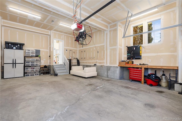 9228 Sori Ln, Highlands Ranch, CO 80126 - garage with a garage door opener and a workshop area