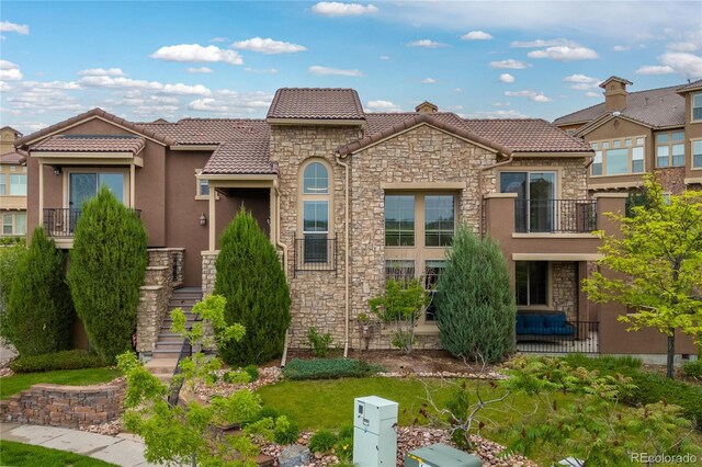 9228 Sori Ln, Highlands Ranch, CO 80126 - view of front of home featuring stone siding, stucco siding, and a tiled roof