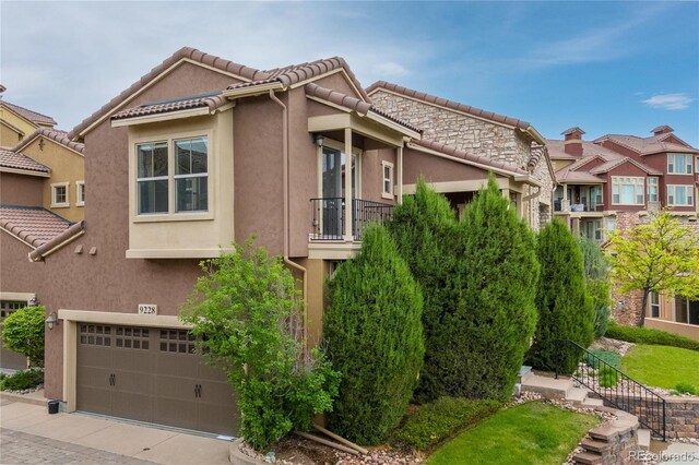 9228 Sori Ln, Highlands Ranch, CO 80126 - view of property exterior with a garage, stucco siding, a tile roof, and driveway