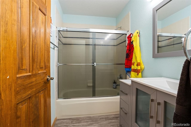 bathroom with vanity and shower / bath combination with glass door