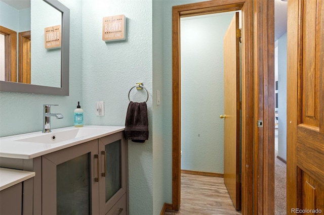 bathroom featuring vanity and wood-type flooring