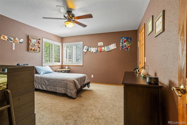 bedroom with a textured ceiling, ceiling fan, and carpet flooring