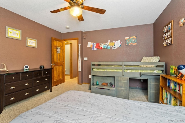 carpeted bedroom with a textured ceiling and ceiling fan