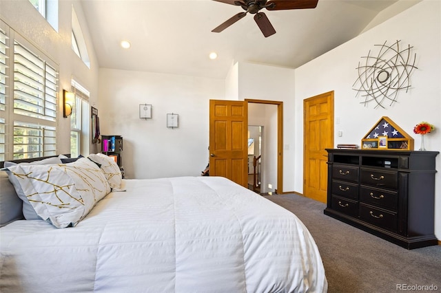 bedroom with ceiling fan, lofted ceiling, and dark carpet