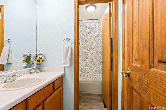 bathroom featuring vanity and shower / bathtub combination with curtain