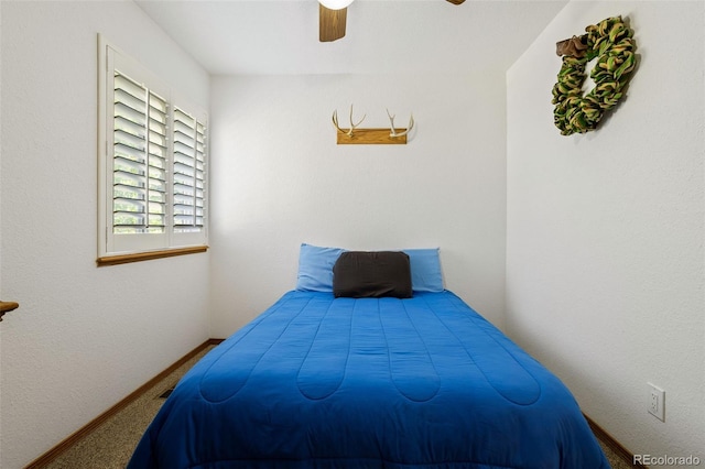 bedroom featuring ceiling fan and carpet