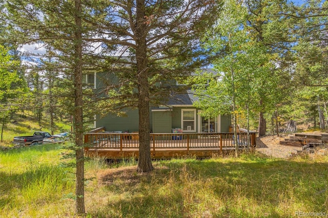 rear view of property with a wooden deck