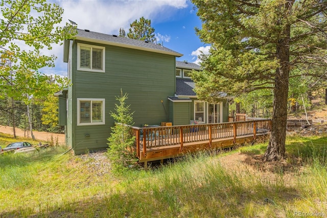 rear view of property featuring a wooden deck