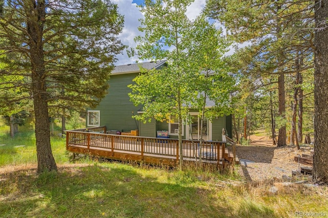 rear view of house featuring a wooden deck