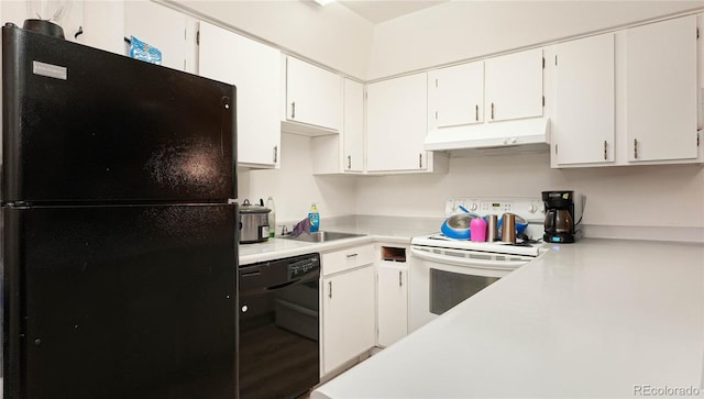 kitchen with sink, black appliances, and white cabinets