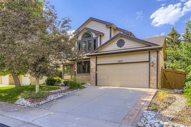 16247 E Belleview Pl, Centennial, CO 80015 - view of front of home featuring brick siding, concrete driveway, and an attached garage