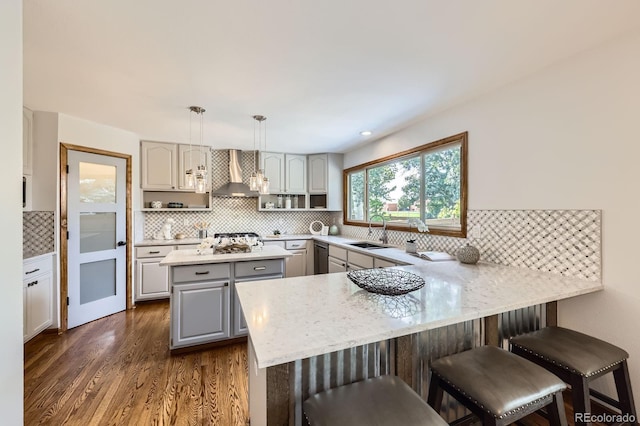 16247 E Belleview Pl, Centennial, CO 80015 - kitchen with gray cabinetry, wall chimney exhaust hood, a peninsula, and tasteful backsplash