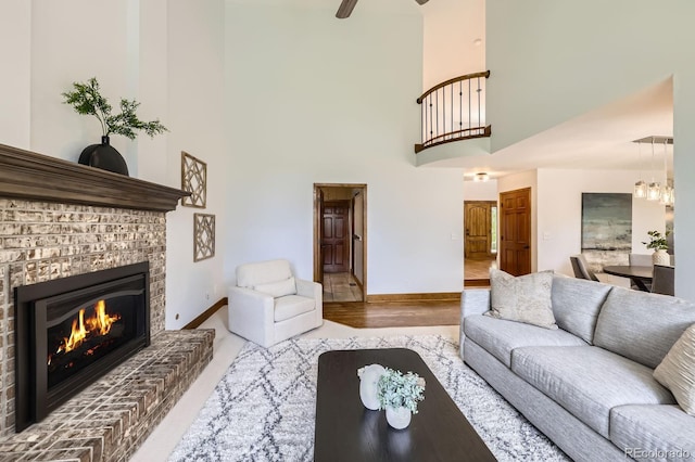 16247 E Belleview Pl, Centennial, CO 80015 - living area with a high ceiling, a brick fireplace, and ceiling fan