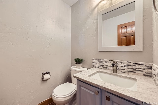 16247 E Belleview Pl, Centennial, CO 80015 - half bath featuring vanity, decorative backsplash, and a textured wall