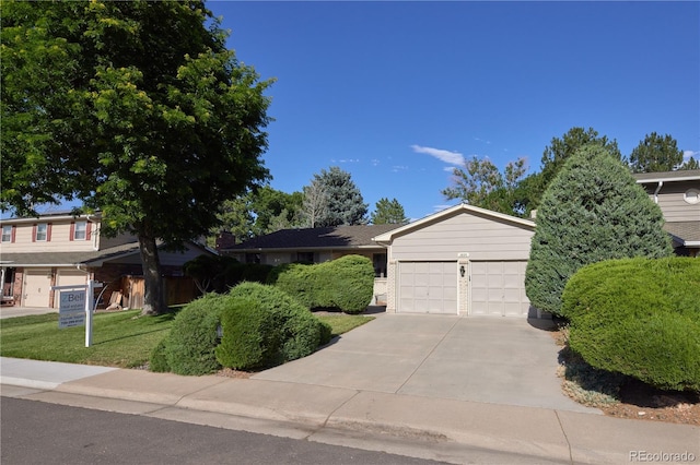 3820 S Harlan St, Denver, CO 80235 - view of front of home featuring driveway, a garage, and a front yard