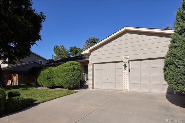 3820 S Harlan St, Denver, CO 80235 - single story home featuring concrete driveway, brick siding, and an attached garage