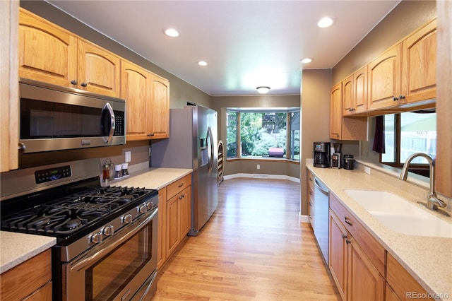 3820 S Harlan St, Denver, CO 80235 - kitchen with appliances with stainless steel finishes, light wood-type flooring, recessed lighting, light stone countertops, and light brown cabinets