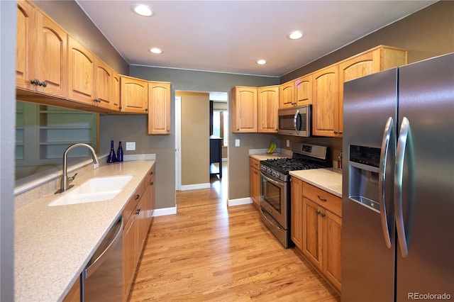 3820 S Harlan St, Denver, CO 80235 - kitchen with stainless steel appliances, recessed lighting, light wood finished floors, and light stone counters