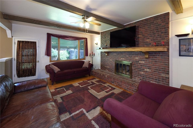 3820 S Harlan St, Denver, CO 80235 - living room with beamed ceiling, a ceiling fan, wood finished floors, and a fireplace