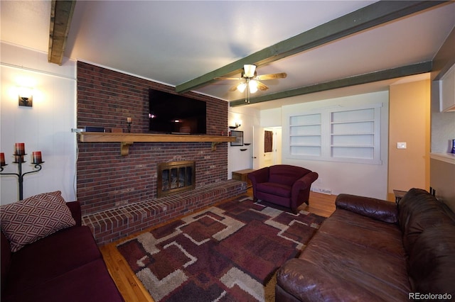 3820 S Harlan St, Denver, CO 80235 - living room featuring wood finished floors, a brick fireplace, beam ceiling, and ceiling fan