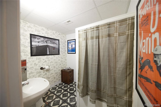 3820 S Harlan St, Denver, CO 80235 - bathroom featuring wallpapered walls, a paneled ceiling, and a shower with curtain