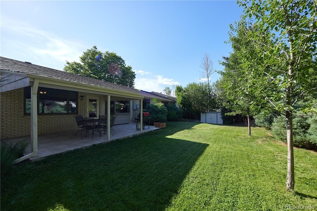 3820 S Harlan St, Denver, CO 80235 - view of grassy yard with a storage shed and a patio area