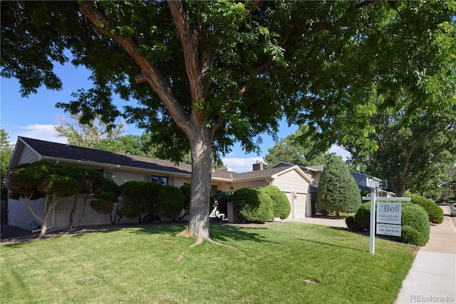3820 S Harlan St, Denver, CO 80235 - view of front facade with an attached garage and a front yard