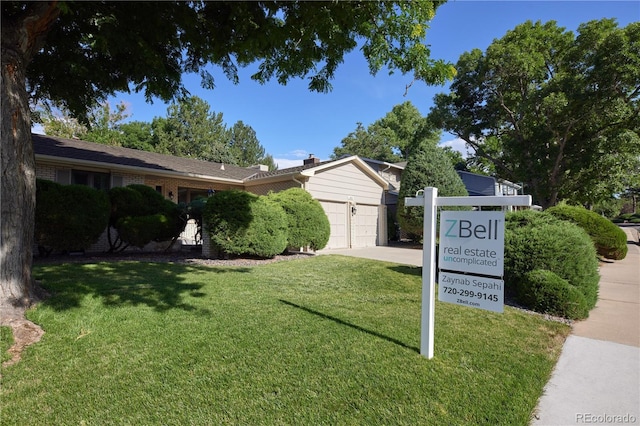 3820 S Harlan St, Denver, CO 80235 - exterior space with an attached garage, a lawn, and driveway