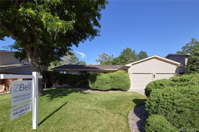 3820 S Harlan St, Denver, CO 80235 - view of front facade featuring a garage and a front lawn