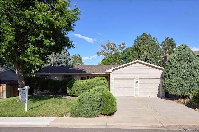 3820 S Harlan St, Denver, CO 80235 - ranch-style home featuring an attached garage, concrete driveway, and a front yard