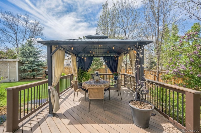 9361 Crestmore Way, Highlands Ranch, CO 80126 - deck with a gazebo, outdoor dining space, an outbuilding, and a shed