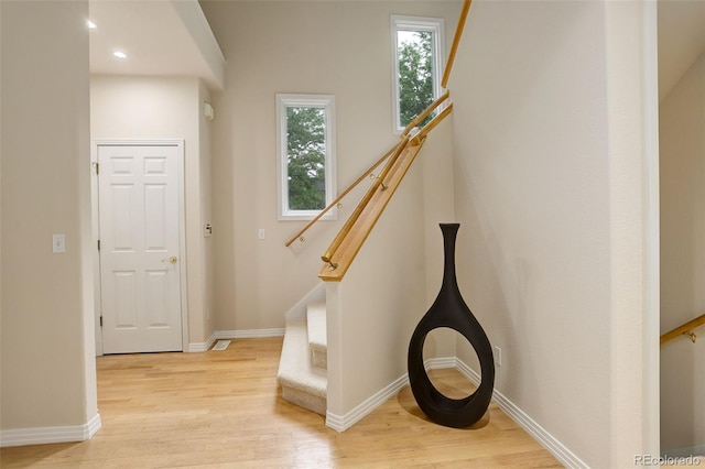 490 Jackson St, Denver, CO 80206 - staircase featuring wood finished floors, baseboards, and recessed lighting