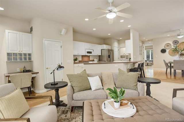 490 Jackson St, Denver, CO 80206 - living area featuring ceiling fan, light wood-style flooring, baseboards, and recessed lighting