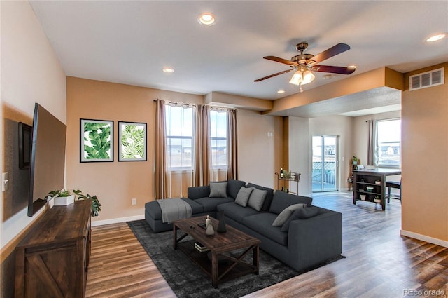 living room featuring visible vents, wood finished floors, baseboards, recessed lighting, and a ceiling fan