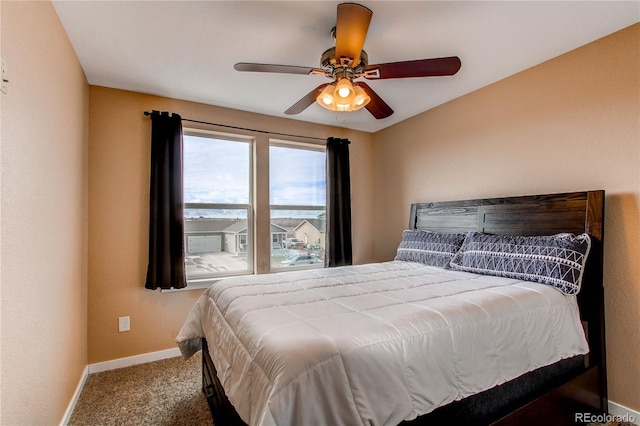 bedroom featuring baseboards, ceiling fan, and carpet