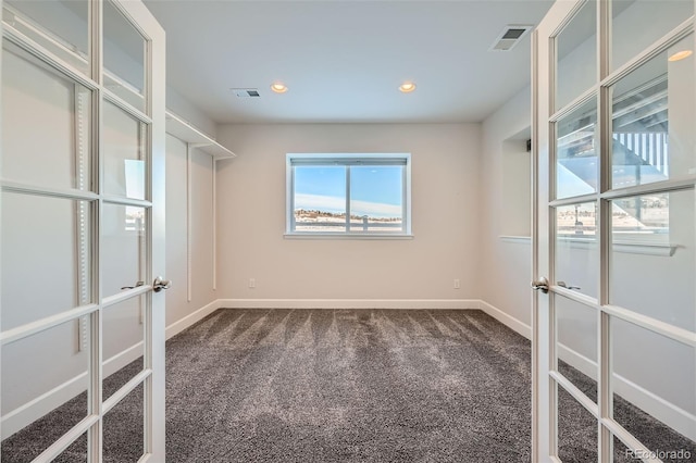 empty room with carpet and french doors