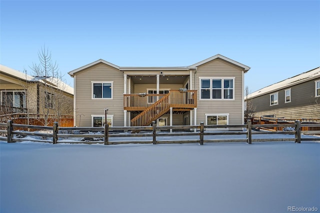 view of snow covered rear of property