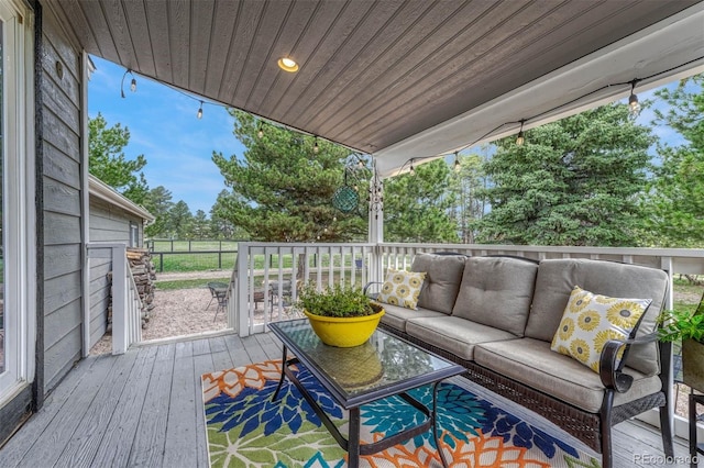 wooden terrace featuring an outdoor living space
