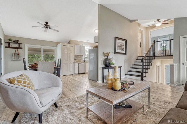 living area featuring a ceiling fan, a healthy amount of sunlight, and light wood finished floors