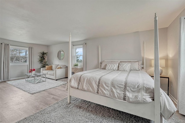 bedroom with baseboards and wood finished floors