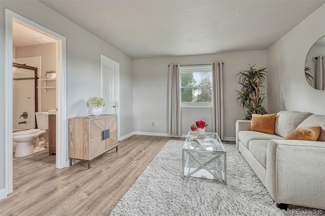 living room with light wood-type flooring and baseboards