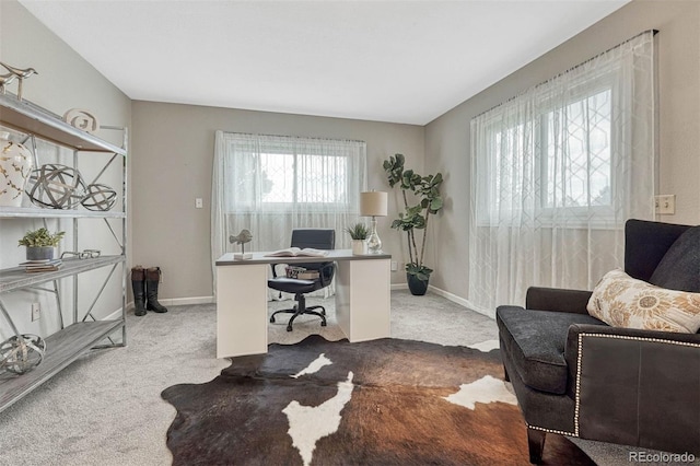 carpeted home office featuring baseboards